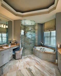 a large bathroom with a walk in shower next to a bathtub and two sinks