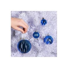 someone is decorating their christmas tree with blue bauble ornament ornaments