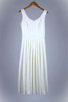 This is a stunning yet simple Laura Ashley wedding dress, made in Great Britain. It is 100% cotton, with a viscose/rayon lining. It has a side zipper. Measurements are as follows:     Size: UK 14, Euro 40, USA 10     Pit to pit, front: 18 1/2"     Pit to pit, back: 18"     Shoulder seam to hem: 49 1/2"     Scoop front to hem: 43"     Waist: 29 1/2"-30"     Scoop dip: 8" This was purchased in 1997, and it has all of the fine quality of that era of Laura Ashley. Simple and elegant. Laura Ashley Wedding, Laura Ashley Wedding Dress, Wedding Dress Ivory, Ivory Wedding Dress, Laura Ashley, Wedding Shop, Bridal Dresses, Bridal Gowns, Wedding Gowns