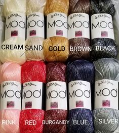 six skeins of moooi yarn in various colors and sizes are shown