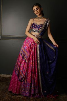 Pink pure silk patola lehenga with printed motifs, mirror embellished drape. Comes with blue sleeveless hand embroidered blouse and georgette hand embroidered dupatta. Paired with Meenakari kundan semi precious jewelled waist belt. 
Components:4
Pattern:Embroidered
Type of Work:Mirror, Resham, Zardozi, Gota
Neckline:Sweetheart
Sleeve Length:Sleeveless
Fabric:Lehenga and Blouse: Silk ; Dupatta: Textured Silk
Color:Pink
Other Details:
Strappy blouse
Tassel hem belt
Layered drape lehenga
Occasion:W Patola Lehenga, Aditi Gupta, Mirror Lehenga, Drape Lehenga, Mehendi Dress, Patola Print, Lehenga And Blouse, Print Lehenga, Pink Lehenga