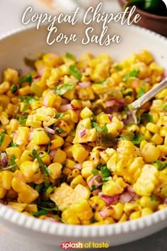 a white bowl filled with corn and garnished with cilantro