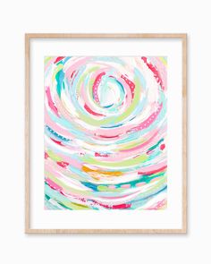 an abstract painting in pink, blue and green with white frame on the wall above it