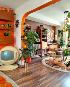 a living room filled with furniture and lots of plants