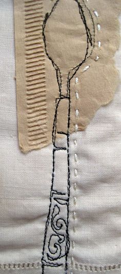 a close up of a piece of fabric with a drawing on it and a comb