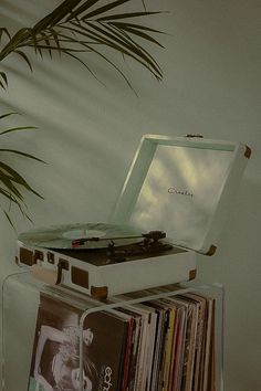 a record player sitting on top of a stack of records