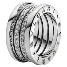 a silver ring with four rows of diamonds on the inside and outside, set in 18k white gold