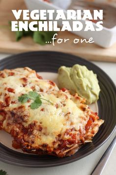 vegetarian enchiladas for one on a plate with guacamole