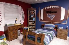 a bedroom with a football themed wall and bed