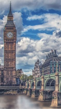 the big ben clock tower towering over the city of london in england, on a cloudy day