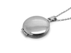 "A necklace in Stainless Steel with a round floral locket. Inner size = 19 mm in diameter. The chain is included and is 18\" (45 cm) long plus a 2\" extender is also attached! The jewelry is Nickel safe and we test it regularly." Adjustable Medallion Locket Necklace, Stainless Steel Round Pendant Locket Jewelry, Stainless Steel Medallion Locket Jewelry, Silver Round Locket Necklace With Lobster Clasp, Silver Medallion Necklace With Locket Pendant, Adjustable Round Locket Pendant Necklace, Silver Medallion Necklace With Locket, Adjustable Round Pendant Locket Necklace, Adjustable Nickel Free Medallion Necklace