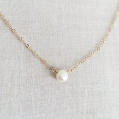 This is a single pearl necklace made of genuine high quality fresh water pearl. This fresh water pearl necklace is light weight and elegant. This tiny pearl necklace is around 5mm. This pearl necklace is great for layering with other gold necklaces. Pearl is June birthstone. Measurement: 5mm fresh water pearl S for Sparkle on Etsy https://www.etsy.com/shop/sforsparkleshop -------------------------------------------------------------------- S for Sparkle Mission We believe that everyone should ha Minimalist White Pearl Drop Necklace, Delicate Chain Pearl Necklace, Pearl White Necklace With Pearl Drop As A Gift, Simple Pearl Drop Necklace For Gifts, Minimalist Pearl Drop Necklace With Round Beads, Delicate Chain Pearl Necklace With Round Beads, Simple White Pearl Necklace As Gift, Pearl Necklace With Pearl Pendant As Gift, Simple Pearl Chain Necklace As Gift