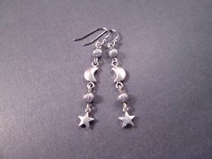 Silver star charms (6mm) and 6x9mm crescent moons, with silver accent beads and french hook ear wires. These earrings measure just under two and 1/4 inches in length.... See more of my designs here; justEARRINGS.etsy.com More Moon/Sun/Star earrings here: https://www.etsy.com/shop/justEARRINGS?ref=simple-shop-header-name&listing_id=98153476&section_id=38062962 And please visit my sister~shops; justCHARMING.etsy.com & BohoDreamJewelry.etsy.com All of my jewelry shops offer FREE SHIPPING! Highlight Silver Crescent Symbolic Earrings, Silver Symbolic Crescent Earrings, Symbolic Silver Crescent Earrings, Silver Symbolic Earrings For Jewelry Making, Celestial Nickel-free Earrings As Gift, Celestial Nickel-free Earrings For Gifts, Nickel-free Celestial Earrings Gift, Silver Moon-shaped Earrings For Gift, Symbolic Moon Shaped Sterling Silver Earrings