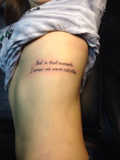 a woman with a tattoo on her arm saying, and in that moment i never were within