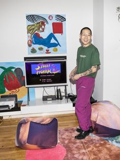 a man standing in front of a flat screen tv