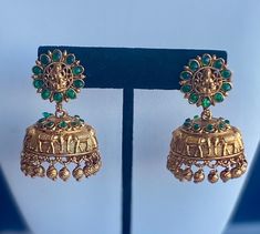 Shop our gorgeous green kemp stone temple jhumka earrings.  Perfect for weddings and parties! Will look best with Indian attire such as sari, lehenga, kurta, suit, etc.         Material: Pure Brass Makes an ideal gift for her and loved ones.  Care Instructions: Clean with a dry cloth. Avoid extreme heat and harsh chemicals such as perfume, deo, hairspray, etc.  Usually arrives within 3-5 business days for US domestic shipping Green Kemp Stone Jhumka Earrings, South Indian Style Temple Jhumka Earrings, Gold Temple Earrings, South Indian jewelry, Temple Jewelry, elephant earrings, gold earrings, Indian Earrings, Traditional jewelry, Green Jewelry, Green Stone, Green Jhumka Earrings, Green Jhumka, Green Jhumki, Gold Jhumka Jhumka Earrings Gold, Green Jhumka, Lehenga Kurta, Temple Earrings, Sari Lehenga, South Indian Style, Gold Jhumka, Stone Temple, Elephant Earrings