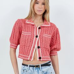 Elevate your casual look with our Cardigan Tee, a cropped knit tee in a trendy reddish-pink hue. Perfect for those preppy yet laid-back spring and summer days. Material & Care: Crafted from 60% cotton and 40% acrylic. Hand wash in cold water with mild detergent. Avoid wringing or twisting. Lay flat to dry away from direct sunlight. If needed, use a cool iron. Size & Fit: Model is 5'9 wearing size small Chic Cropped Pink Cardigan, Pink Cropped Cardigan For Spring, Pink Short Sleeve Cotton Knit Top, Trendy Cropped Cotton Cardigan, Trendy Short Sleeve Sweater For Day Out, Casual Pink Cropped Knit Sweater, Preppy Pink Tops For Fall, Casual Pink Knit Cropped Sweater, Trendy Knit Cropped Sweater For Summer