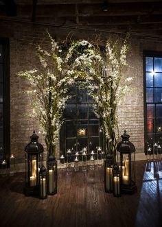 an indoor area with lanterns, flowers and candles