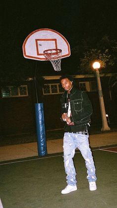 a man standing in front of a basketball hoop