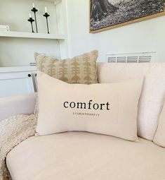 a white couch with a comfort pillow on it