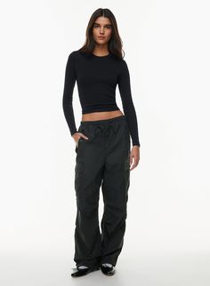 Nylon Wide Leg Cargo Parachute Pants, Nylon Wide Leg Parachute Pants With Cargo Pockets, Wide Leg Nylon Parachute Pants With Cargo Pockets, Sporty Nylon Parachute Cargo Pants, Sporty Nylon Parachute Pants In Cargo Style, Utility Nylon Parachute Pants With Drawstring, Sporty Parachute Pants With Cargo Pockets For Fall, Sporty Cargo Parachute Pants For Fall, Sporty Cargo Style Parachute Pants For Fall