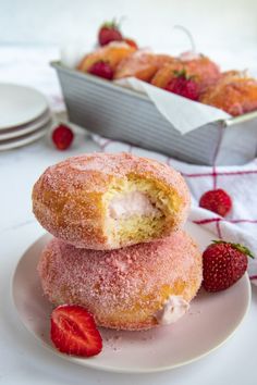 two strawberry donuts stacked on top of each other