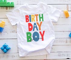 a white shirt with the words birth day boy on it next to legos and building blocks