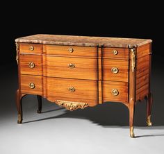 an antique chest of drawers with marble top