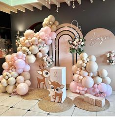 a room with balloons and deer decorations on the wall, along with an entrance sign that says i love you