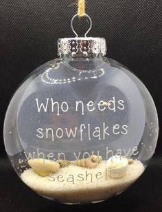 a glass ornament with sand and shells in it that says who needs snowflakes when you have seashells