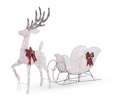 two white reindeer pulling a sleigh with red bows