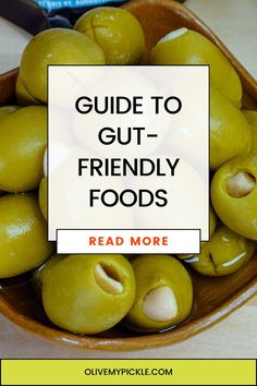 green olives in a bowl with the words guide to gut - friendly foods read more