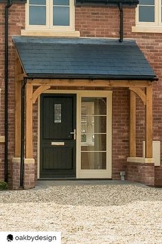 a brick building with a black front door