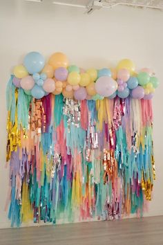 balloons and streamers are hanging on the wall