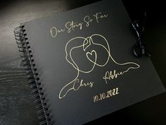 a wedding guest book with two hearts and the words our story so far on it