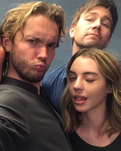 two men and a woman taking a selfie