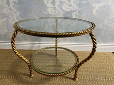 a glass and metal table sitting on top of a carpeted floor next to a wall