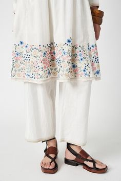 White kurta with smocked bodice and floral thread embroidered motifs on hem. Comes with pant. - Aza Fashions Traditional Sets With Straight Pants For Spring, Traditional Spring Sets With Straight Pants, Spring Sets With Intricate Embroidery And Straight Pants, Spring Off White Sets With Embroidered Border, Cotton Sets With Embroidered Border, Traditional Embroidered Pants For Spring, Traditional Sets With Yoke For Spring, Traditional Embroidered Spring Pants, Traditional Spring Set With Yoke Detail