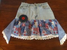 One of a kind....Boho Western Chic Fun Whimsical Country Denim Skirt Hi there, My company name is Mimi's Sewtique, I love to create and make unique items. This denim western boho skirt was repurposed from Ladies size 11 light wash Levis jeans.  Skirt is trimmed in eyelet lace and adorned with a handmade denim flower. The bottom of the skirt has a western patchwork print, with tiered triangles of royal blue gingham on both sides.  There are some paint spots that I've included close up pics of, but to me, adds character to the skirt.  All seams are serged for quality.   How cute with boots or even flip flops! My name is Christine and my company's name is Mimi's Sewtique, I love to create and make unique items. All my pieces are made with love, passion and are one of a kind, unique. I have be Bohemian Mini Denim Skirt, Bohemian Patchwork Denim Skirt For Summer, Bohemian Cotton Denim Skirt For Festival, Handmade Bohemian Bottoms For Spring, Bohemian Denim Mini Skirt, Bohemian Denim Skirt For Festival, Fitted Bohemian Patchwork Denim Skirt, Bohemian Cotton Mini Denim Skirt, Country Skirt