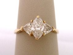 an engagement ring with three pear shaped diamonds