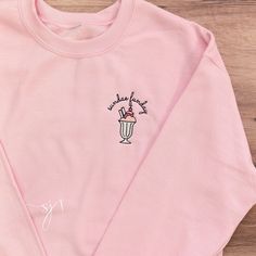 Sundae Funday! This is a retro ice cream diner inspired design 🍦 This design is embroidered on a light pink crewneck sweatshirt. It is unisex sized. This means the sizing is boxy, not fitted like women's, but it is not oversized. It is true to size. This design is not customizable. This design and colors cannot be altered, resized, or changed. Specifications: 8 oz.(US) 13.3 oz.(CA), 50/50 preshrunk cotton/polyester Air jet yarn = softer feel and reduced pilling Double needle stitching at should Trendy Embroidered Pink Sweatshirt, Casual Pink Sweatshirt With Embroidered Logo, Pink Sweatshirt With Custom Embroidery In Relaxed Fit, Pink Trendy Sweatshirt With Embroidered Logo, Trendy Pink Sweatshirt With Embroidered Logo, Trendy Pink Sweatshirt With Embroidered Graphics, Pink Crew Sweatshirt With Embroidered Graphics, Pink Custom Embroidery Sweatshirt For Streetwear, Pink Retro Cotton Sweatshirt