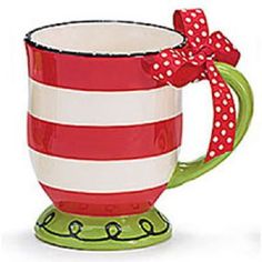 a red and white striped coffee mug with a bow on the handle, sitting in front of a white background