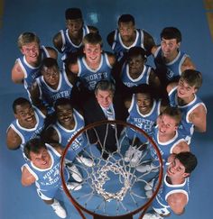 a group of young men standing next to each other in front of a basketball hoop