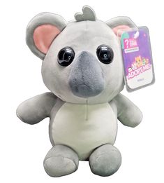 a small stuffed animal with big eyes and an ear tag in front of a white background