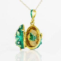 "Jewelry locket pendant with the frog surprise inside. Enameled and 24 K gold plated over solid sterling silver, this pendant is designed and made in our NJ shop in the tradition of Faberge jewelry. A green frog , in a color, matching the outside surface of the pendant, sits on white leaves, and is fixed steadily inside the locket. The egg is 20 mm (0.7\") long without a bail for a chain. It comes with 18' sterling silver gold plated chain and in a gift box. If you feel that you need a longer ch Black Locket, Cute Green Frog, Jewelry Locket, Bouquet Jewelry, Faberge Jewelry, Frog Necklace, Faberge Egg, Green Pendant, Sterling Silver Locket