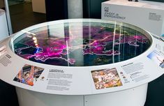 a glass display with pictures and information about the city in it's centerpiece