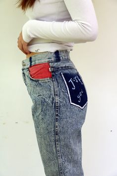 "Vintage acid wash jeans a lot of love left in these jeans, high waist tapered legs, pockets in colors - red blue, and yellow, embroidered back pocket (looks like hand embroidered by the previous owner ) the belt loops were removed -Looks appropriate with the overall look of the jeans, zipper Ankle, brand TOPPER - vintage Israeli brand. aside from minor signs of wear, good vintage condition, clean ready to wear. *Model is 5'7\" and a size small for reference** Approximate size: S -  Please refer Red Denim Bottoms With Five Pockets, Red Relaxed Fit Denim Jeans, Red Denim Jeans With Relaxed Fit, Red Wide-leg Denim Jeans, Red Retro Denim Bottoms, 90s Inspired Medium Wash Cotton Jeans, High Waist Red Denim Jeans, Red High Rise Jeans With Five Pockets, High Rise Red Denim Pants