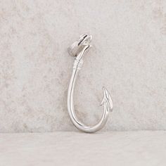 This sterling silver fish hook pendant weighs 1.7 grams. It measures 1 3/8" in height, including the bail, and 1/2" in length. It could be used as a charm but because of the bail, it would usually be a pendant. Condition: Pre-Owned *All items are thoroughly inspected for quality assurance purposes Elegant Metal Jewelry With Fish Hook, Sterling Silver Jewelry With Fish Hook For Gift, Sterling Silver Fish Hook Jewelry Gift, Adjustable Gold Jewelry With Fish Hook, Adjustable Sterling Silver Fish Hook Jewelry, Silver Adjustable Fish Hook Earrings, Gold Fish-shaped Earrings With Fish Hook, Silver Fish-shaped Earrings With Fish Hooks, Silver Fish