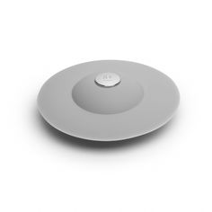 a white plate with a button on the top and bottom part of it, in front of a white background