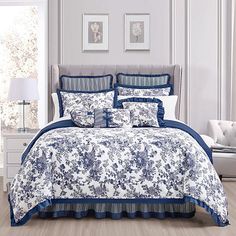 a blue and white comforter set in a bedroom